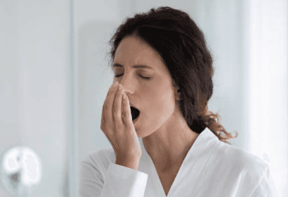 woman checking is she has bad breath