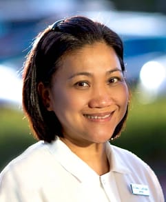 Meet Dr. Chona Lardizabal | Experienced Dentist | We Care Dental Dr. Chona Lardizabal, experienced dentist at We Care Dental, smiling warmly in a professional headshot.