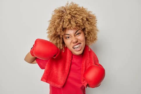 Protect Your Smile: Sports Guards and Night Guards in Dublin, CA Female boxer sports guard protection We Care Dental Dublin