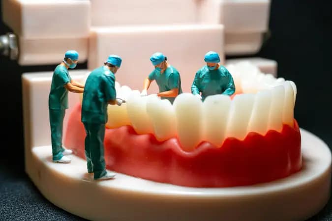 Miniature dental surgeons examining a tooth model during a routine cleaning, symbolizing early detection of oral health issues like cavities, gum disease, and oral cancer